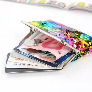Detail view of the spacious interior of a 4-inch rainbow sequin coin purse with metal clasp