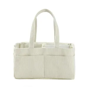 Detail view of corduroy diaper bag with internal dividers and soft ribbed texture