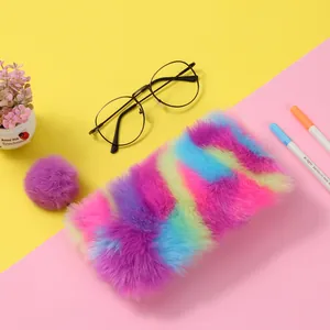 Detailed texture of rainbow tie-dye plush pencil case with a purple pom-pom keychain