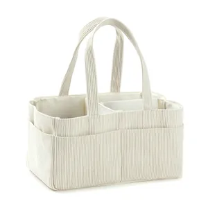 Large corduroy diaper caddy bag in ivory white with multiple storage pockets and dividers