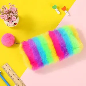Detailed macro view of rainbow plush pencil case with large pink fur pompom zipper puller