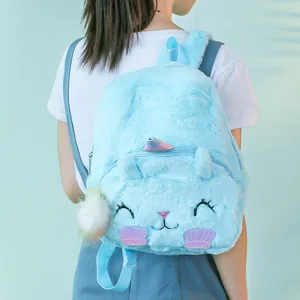 Detail of light blue plush unicorn backpack showing soft faux fur and shell appliques