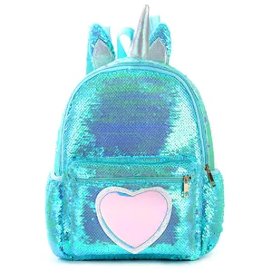 Detail of sequin unicorn backpack with silver glitter horn and pink heart pocket