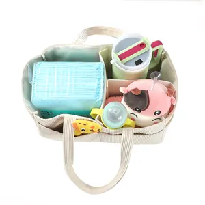 Detail view of corduroy diaper bag showing internal compartments with baby essentials