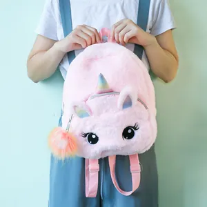 Pink plush unicorn backpack for girls featuring rainbow horn and fuzzy pompom keychain