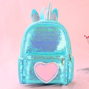 Detailed view of unicorn backpack with shimmering blue sequins and a large pink heart patch