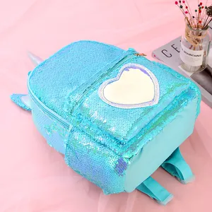 Close-up of sky blue sequin unicorn backpack with a glittery heart and soft pastel accents