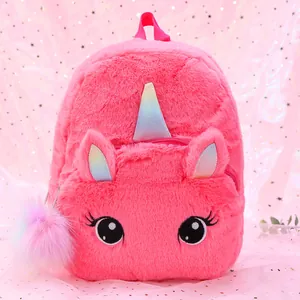 Close-up of pink plush unicorn backpack with soft fur texture and glitter horn detail