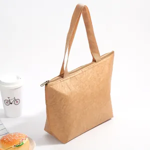 Detail view of brown Tyvek paper lunch bag with zipper and soft woven handles