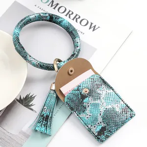 Detail of teal faux snakeskin wristlet keychain with card holder and tassel
