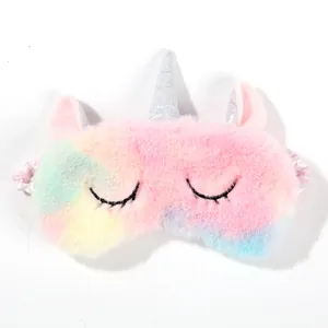 Detail of plush unicorn eye mask with rainbow gradient fur and silver glitter horn