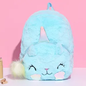Detailed view of light blue plush unicorn backpack featuring soft fur and rainbow horn