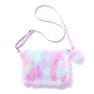 Detail of colorful rainbow plush crossbody bag with soft fur texture and a pom-pom charm