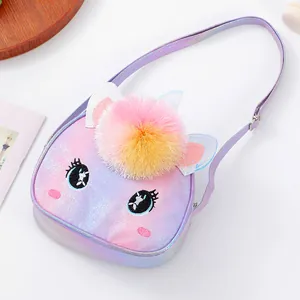 Close-up of unicorn girl purse with glitter texture, large pompom and embroidered eyes