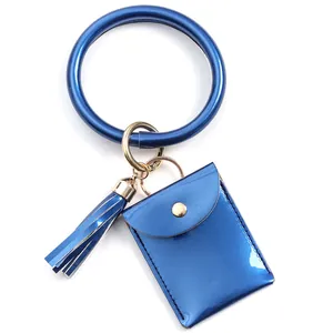 Close-up of royal blue PU leather wristlet keychain with coin pouch and tassel detail