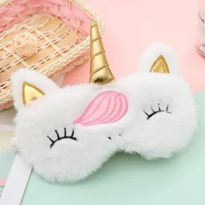 Detail of plush unicorn sleep mask with golden horn and soft faux rabbit fur texture
