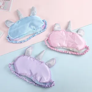 Unicorn plush sleep masks in light blue, pink and purple with satin fabric and silver horns
