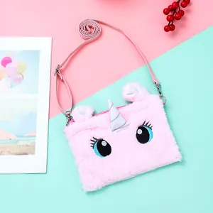 Detail of pink plush unicorn crossbody bag with silver horn and adjustable shoulder strap
