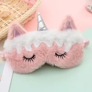 Detail of pink and white plush unicorn sleep mask with silver horn and embroidery