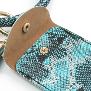 Macro detail of blue snake-pattern leather with gold metal clasp and soft suede lining