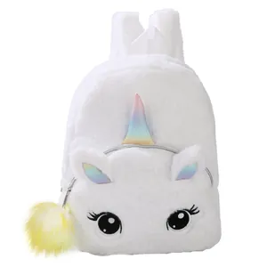 Close-up of white plush unicorn backpack with glitter horn and soft fur texture
