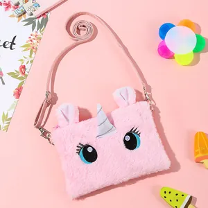 Detail of soft pink plush unicorn crossbody bag with silver glitter horn and cute eyes