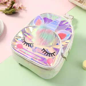 Detail of laser iridescent unicorn backpack with 3D colorful pom-poms and embroidery