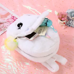 Detail of plush unicorn backpack featuring soft white fur and colorful pompom charms