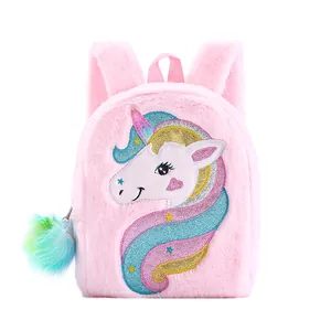 Detail of pink plush unicorn backpack with glitter embroidery and colorful pompom charm