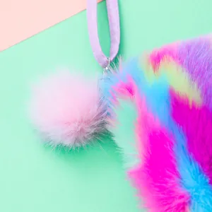 Close-up of rainbow plush crossbody bag texture with a cute pink fluffy ball charm