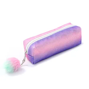 Macro shot of pink and purple gradient glitter pencil case with cute fuzzy pom-pom charm
