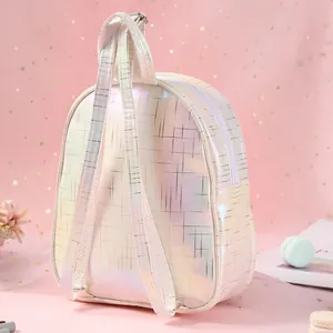 Detail of the holographic white TPU unicorn backpack with gold grid pattern and metal buckles