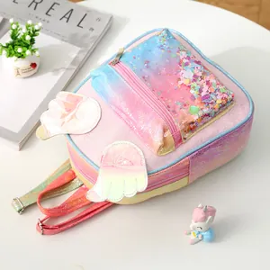 Close-up of rainbow sequin kids backpack featuring colorful wings and glitter shell pocket