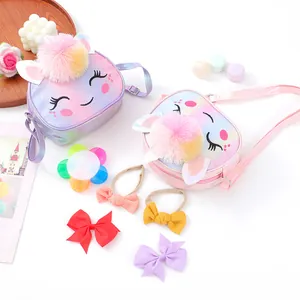 Detail of glitter heart crossbody bags with rainbow fur balls and matching hair accessories