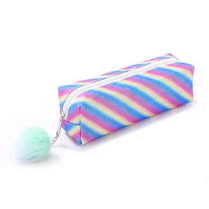Macro shot of glitter rainbow pencil case featuring a soft teal faux fur pompom keychain