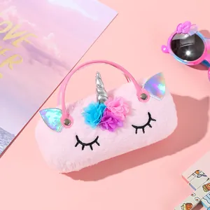 Close-up of plush unicorn handbag featuring pink faux fur, silver horn, and floral details