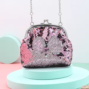 Detail of glitter sequins with silver kiss-lock clasp on pink crossbody bag