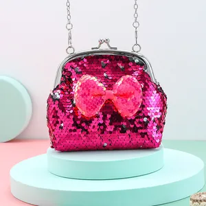 Close-up of sequin shoulder bag featuring a large pink bow and silver metal clasp