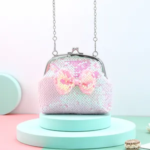 Detail of pink sequin crossbody bag with bow decoration and silver kiss lock closure