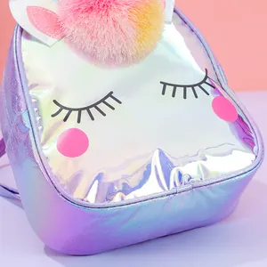 Close-up of laser unicorn backpack featuring a plush ball and embroidered eyelashes