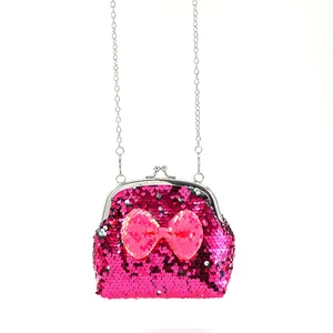 Detail of rose red sequin coin purse with a pink bow and silver chain strap
