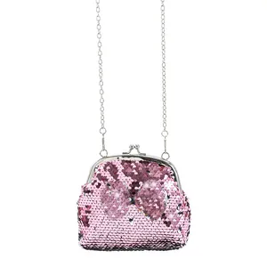 Detailed view of pink sequin coin purse with bow accent and silver kiss-lock closure