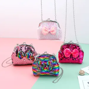 Macro detail of sequined mini crossbody bags with bow accent and metal chain strap