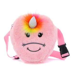Détail du sac licorne rose en peluche montrant la texture douce et les pompons arc-en-ciel