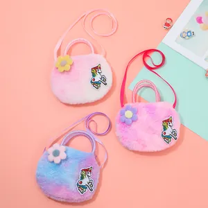 Detail of colorful plush unicorn shoulder bag with embroidery and 3D floral accent