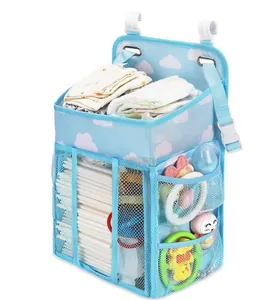 Detail of hanging baby crib diaper caddy with multiple compartments and mesh storage