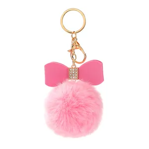 Rosa Plüsch-Pompon-Schlüsselanhänger mit Strass-Schleife und Goldkarabiner für Taschen