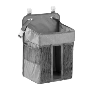 Detail of grey nursery organizer with mesh pockets and hooks for baby crib hanging storage