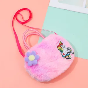 Detail of pink plush unicorn crossbody bag featuring sequins and soft floral accents