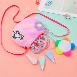 Close-up of pink plush unicorn shoulder bag featuring colorful embroidery and accessories